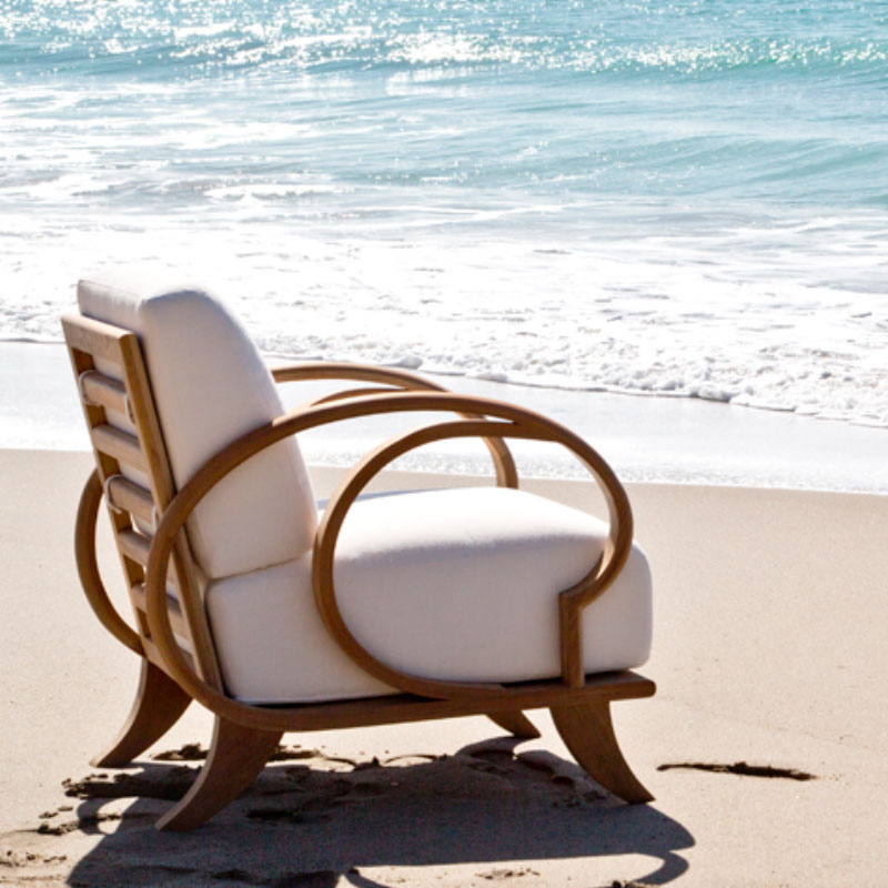 A luxury chair from Marcali Furniture on the beach next to the ocean