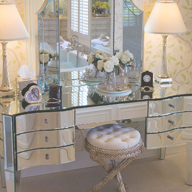 Mirror vanity table and cushion chair from Nancy Corzine Furniture